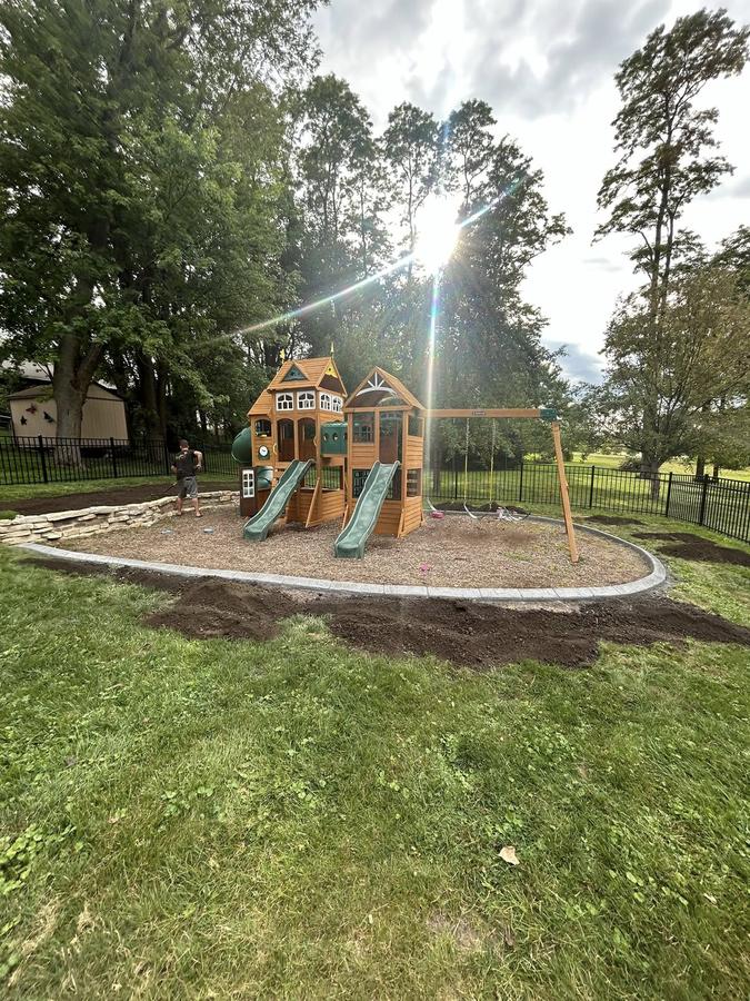 Decorative concrete curbing installed around a landscape tree bed in Central Illinois.