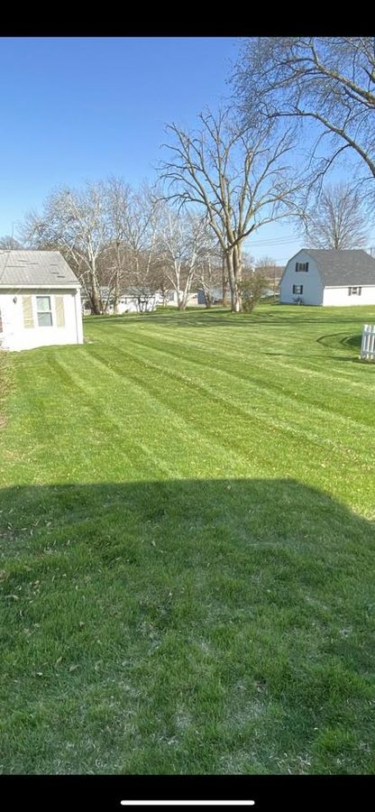 Freshly mowed lawn and clean landscaping maintenance on a residential property.