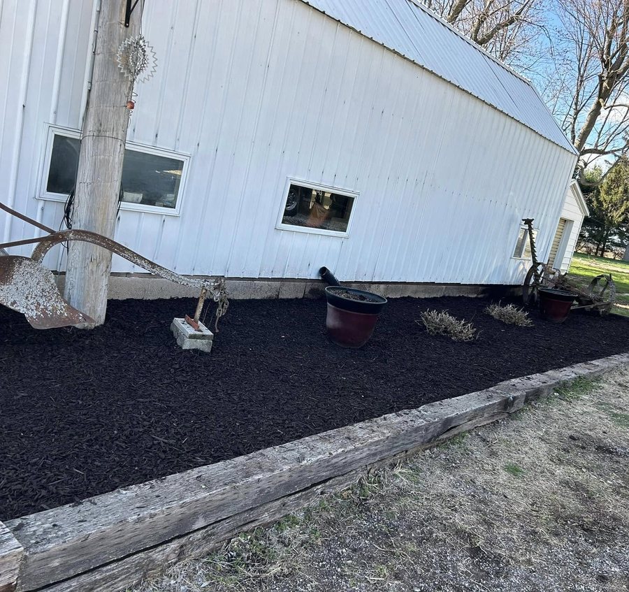 Fresh mulch bed prepared for a clean decorative concrete border installation.